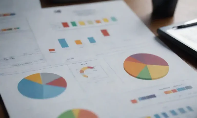 Professional analyzing brand elements with charts and logos on a table.