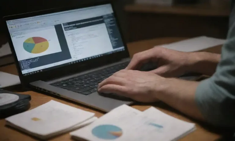 Person studying PPC strategies on a laptop with books and charts nearby.