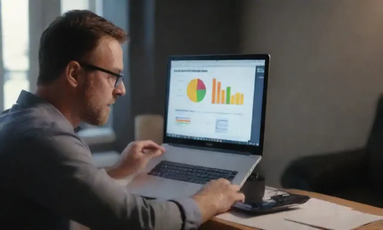 A marketer analyzing data charts and demographics on a laptop for targeted email campaigns.