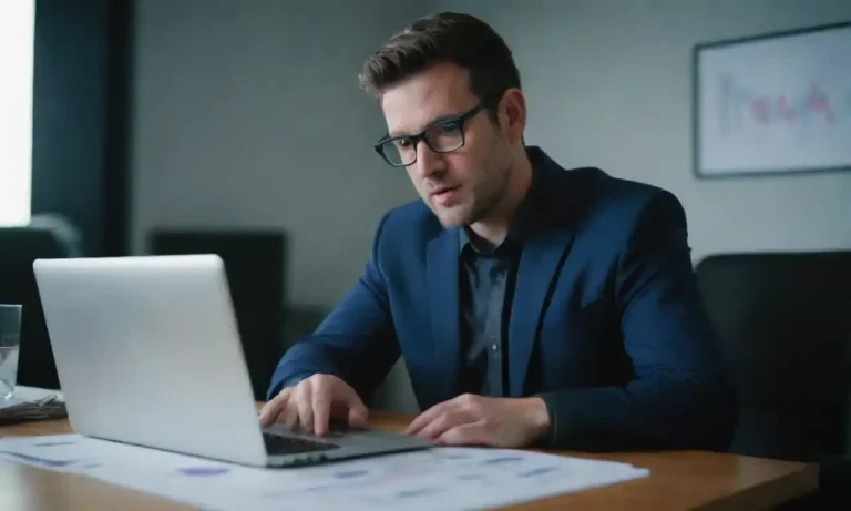 A professional analyzing data charts and leads on a laptop in a modern office.