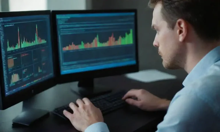 Data analyst examining charts and graphs on a computer screen