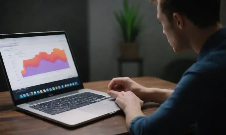 Marketer analyzing email performance metrics on a laptop while comparing two distinct email designs.