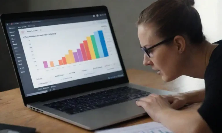 Marketer analyzing PPC metrics on a laptop with charts and keywords displayed.