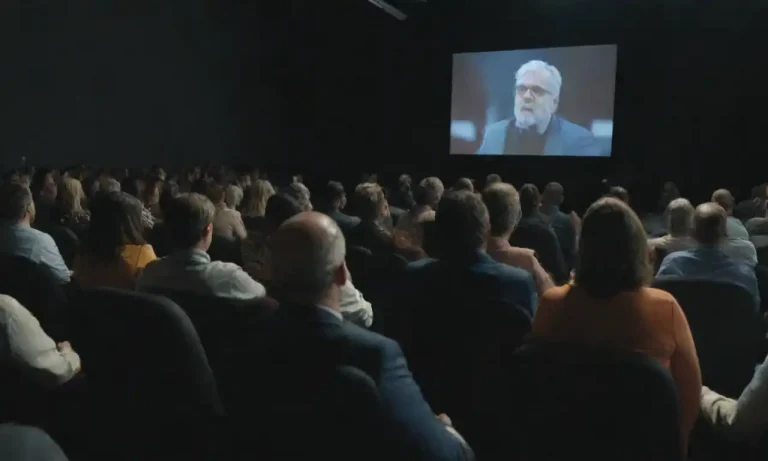 A speaker engaging an audience with visuals and interactive elements in a marketing seminar.