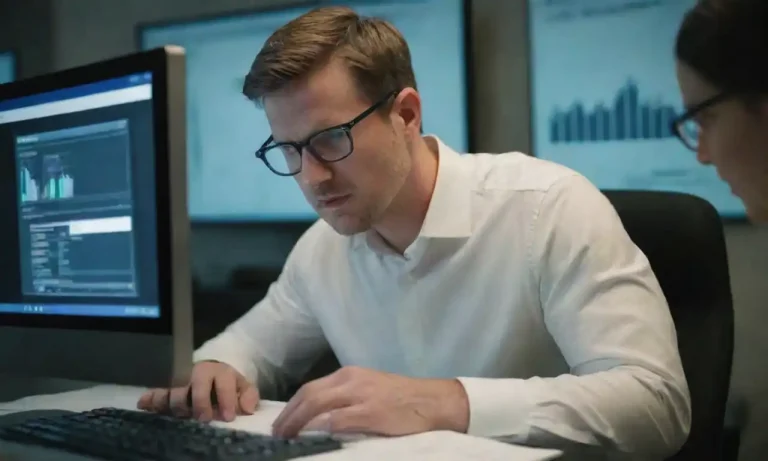 Marketer analyzing data on a computer while designing remarketing ads.